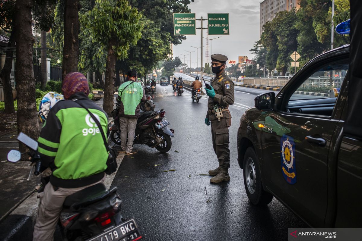 Ojek taxi driver is on the road amid Jakarta lockdown, to earn money