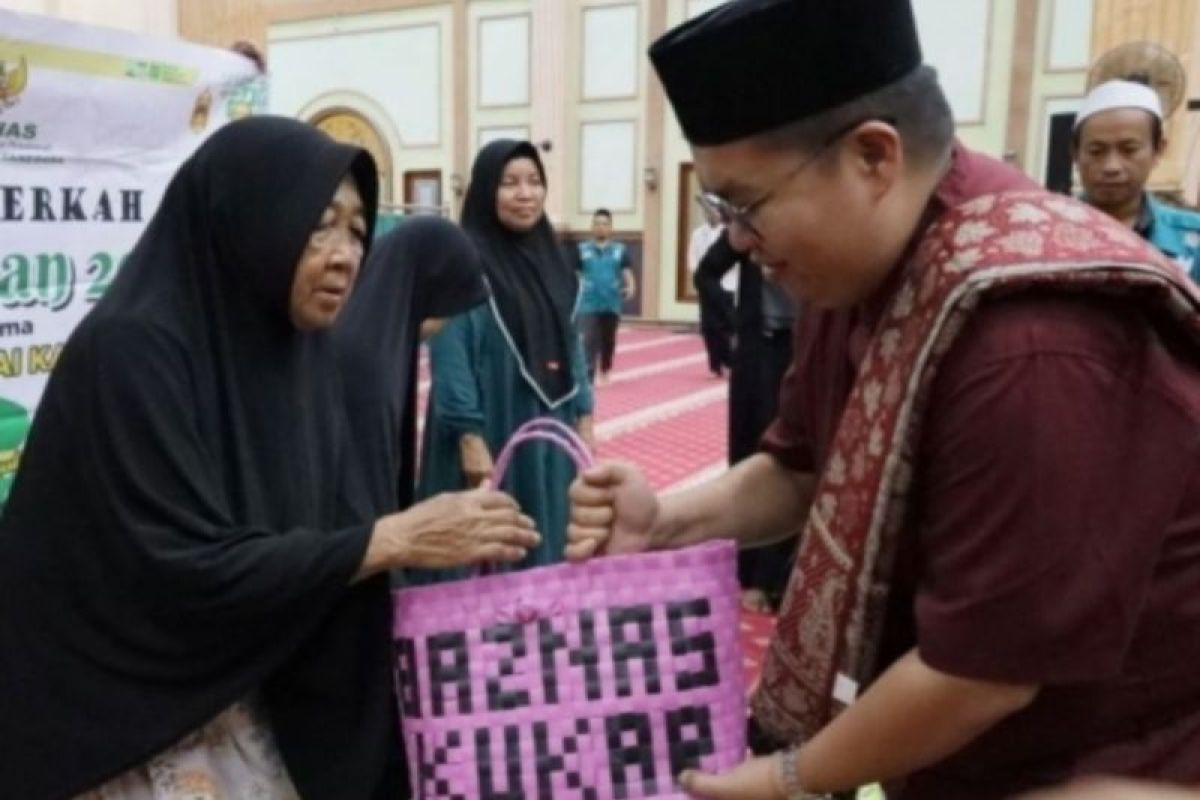 Wakil Bupati Kutai Kartanegara Rendi Solihin (kanan) menyerahkan bantuan dari Baznas Kukar untuk warga prasejahtera di Kecamatan Muara Muntai, Kukar, Kaltim. ANTARA/HO-Prokom Kukar.   