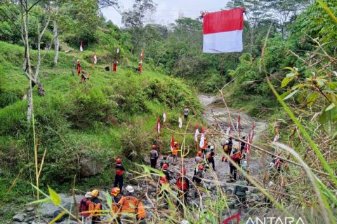 Pengibaran bendera merah putih di atas sungai kaki Gunung Merapi